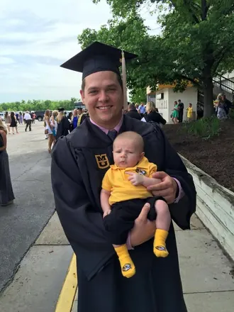 College graduation, with a baby in my arms.