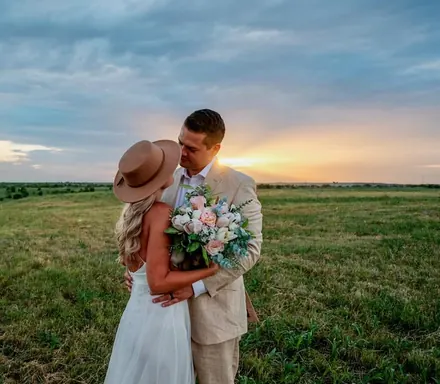 Our wedding, out under the evening sky.